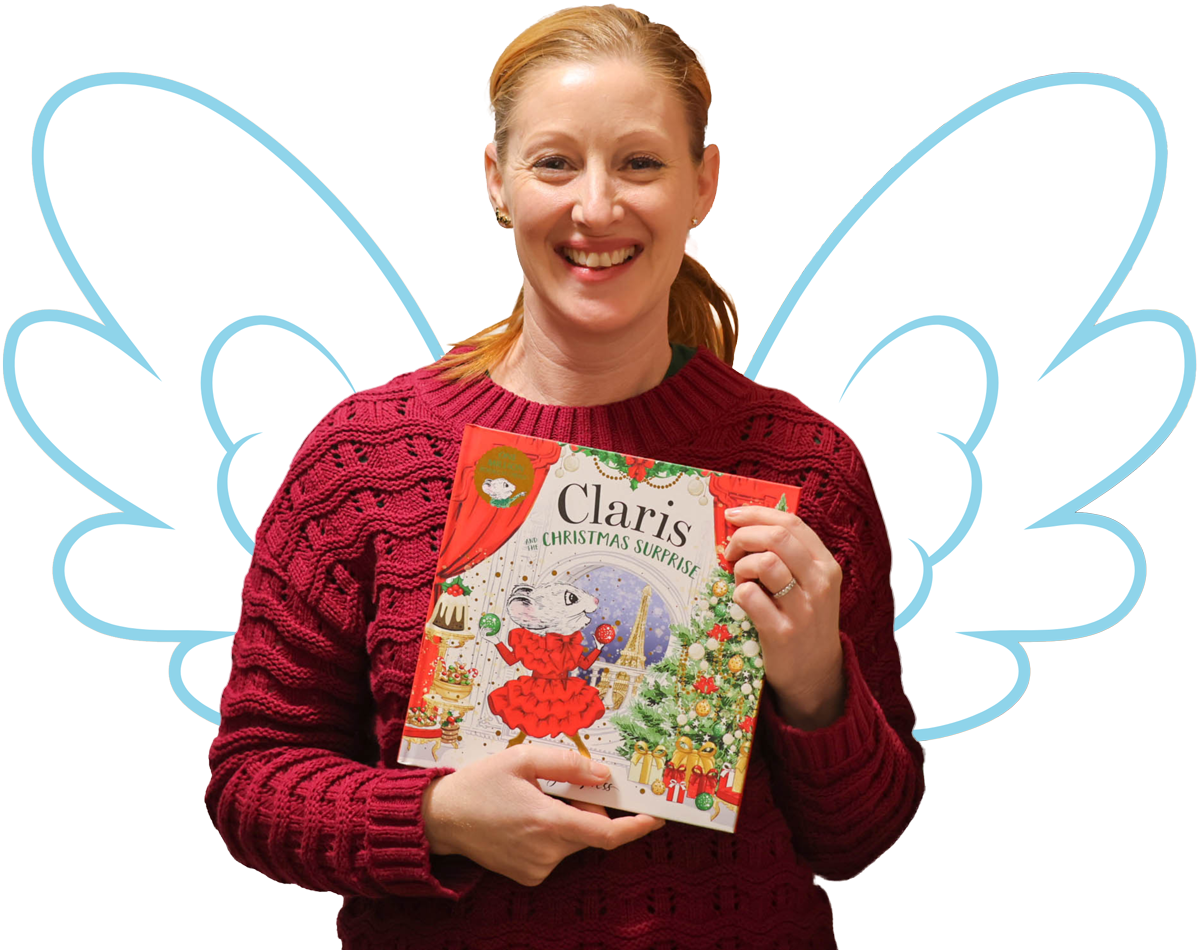 Image of a person holding a kids book. They have illustrated angel wings.