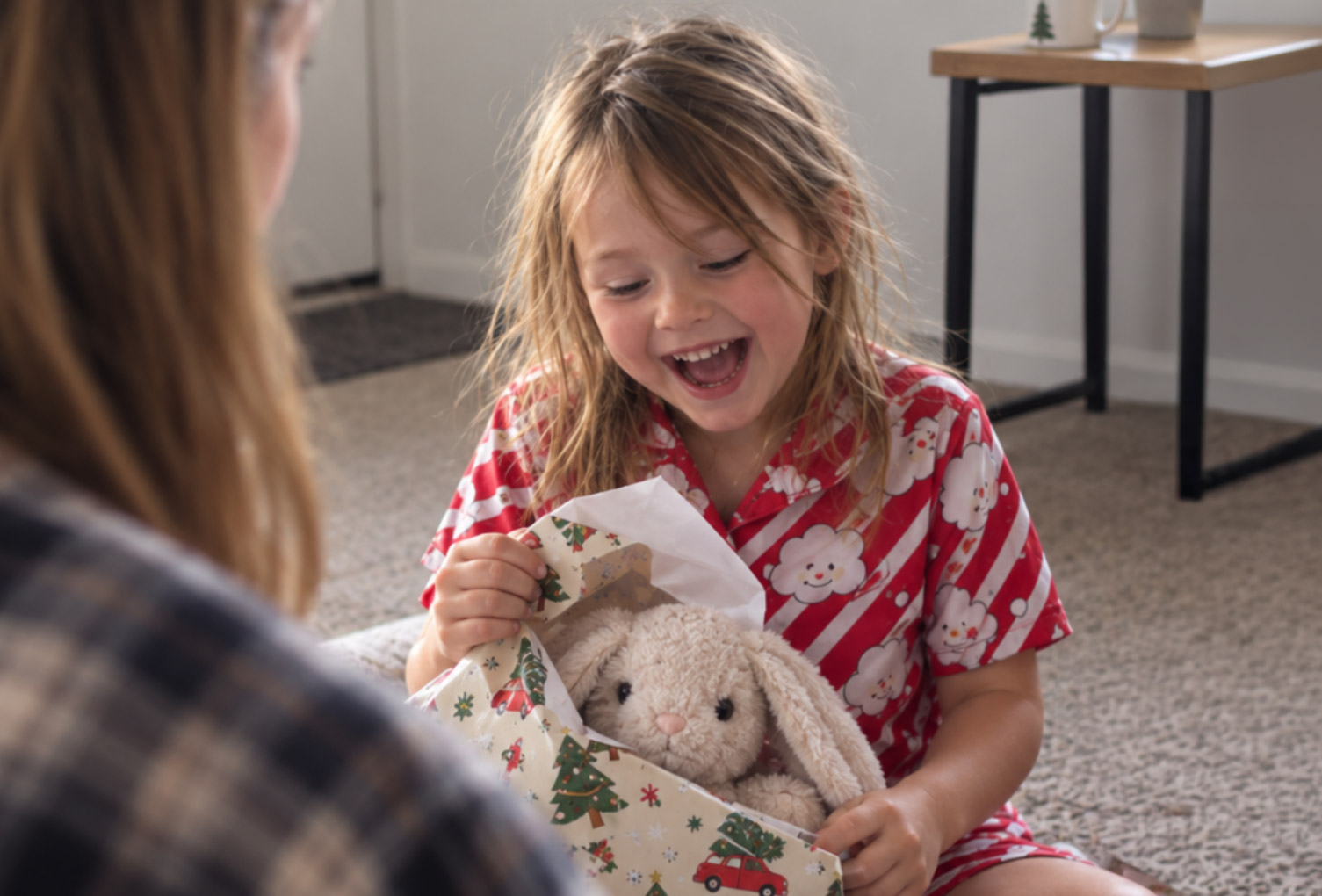 A happy child opening a Christmas gift